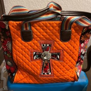 Beautiful orange stitching around a lovely cross and flowered sides. Pleather